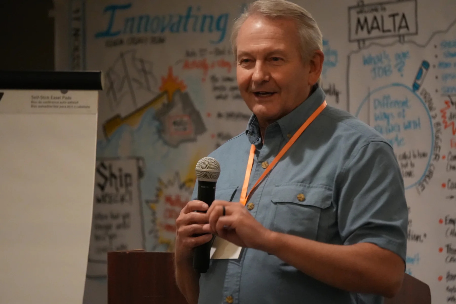 Brett speaking at a gathering.