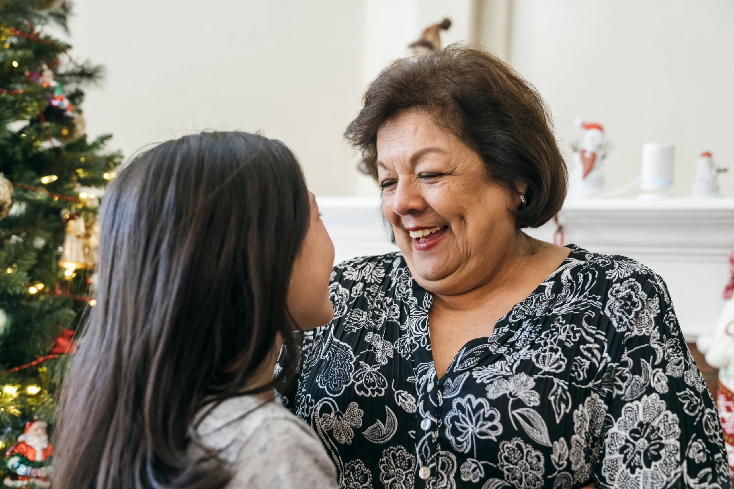 Two women embracing at a community gathering.