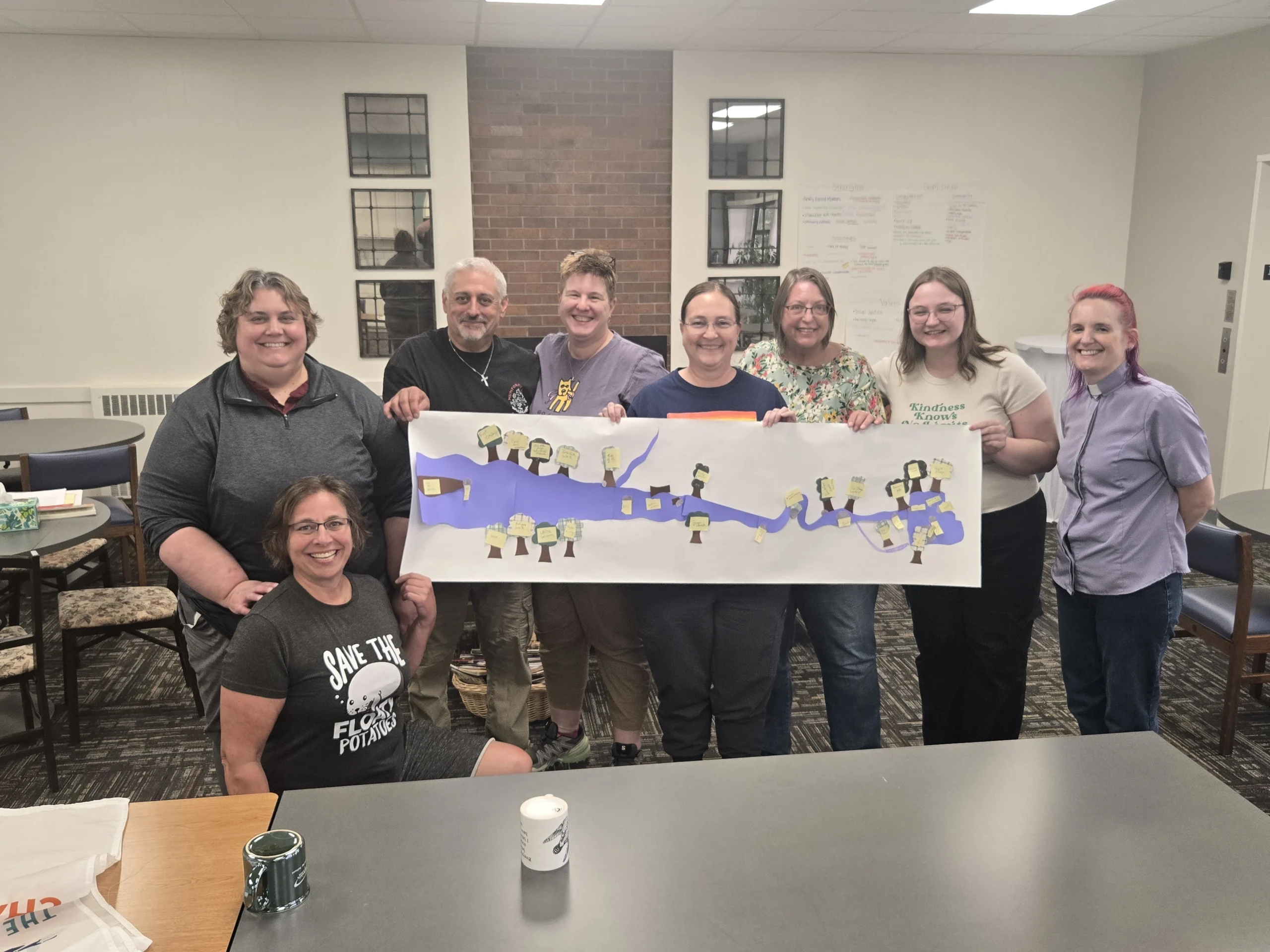 Changemaker team holding a community project banner.