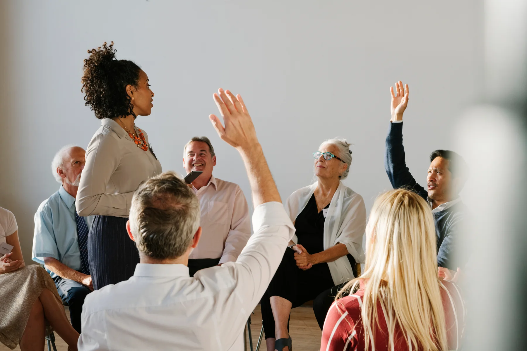 Young adult leading a group conversation.