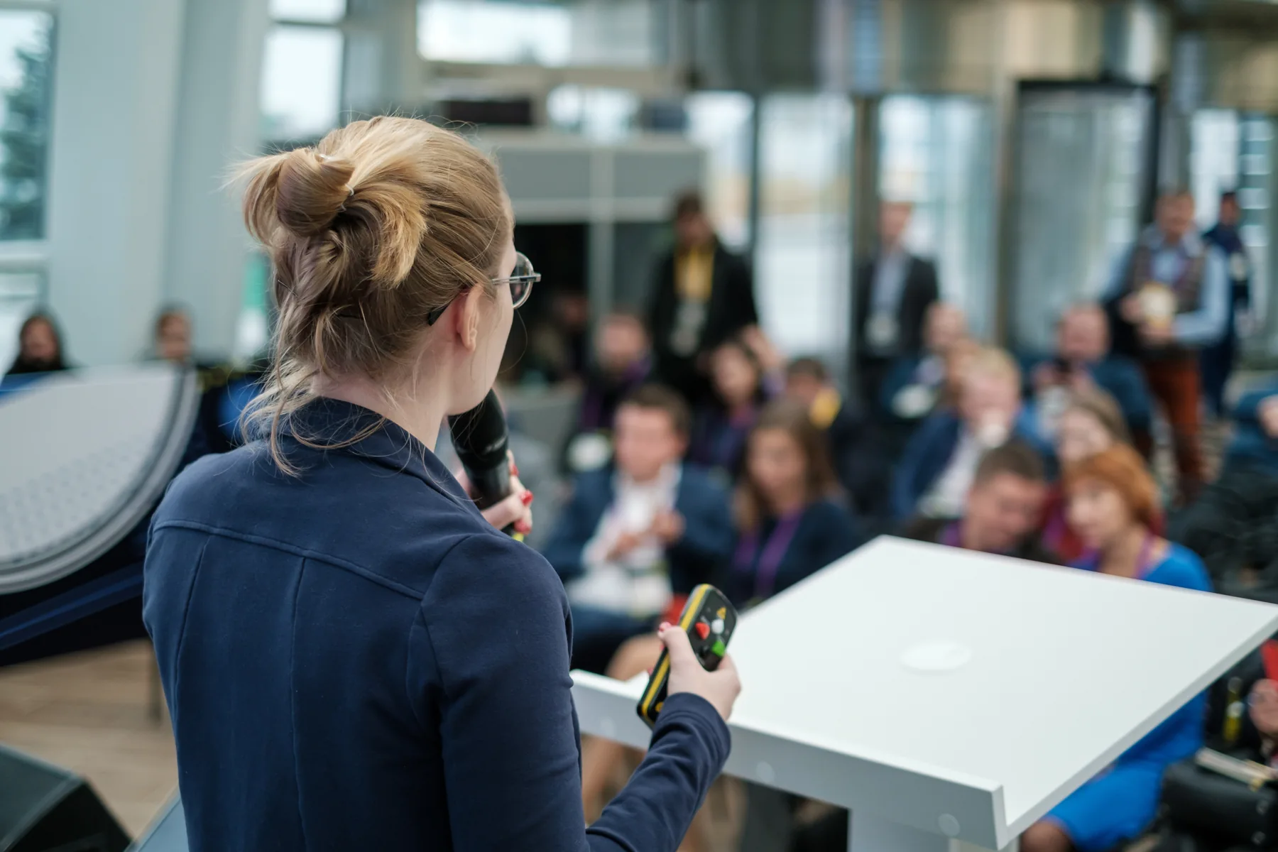 Young adult speaking at a community gathering.