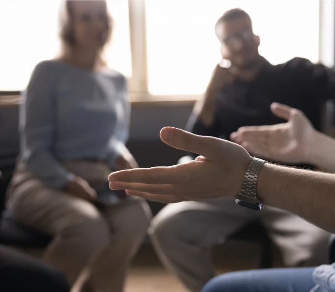 People discussing their work together around a table.